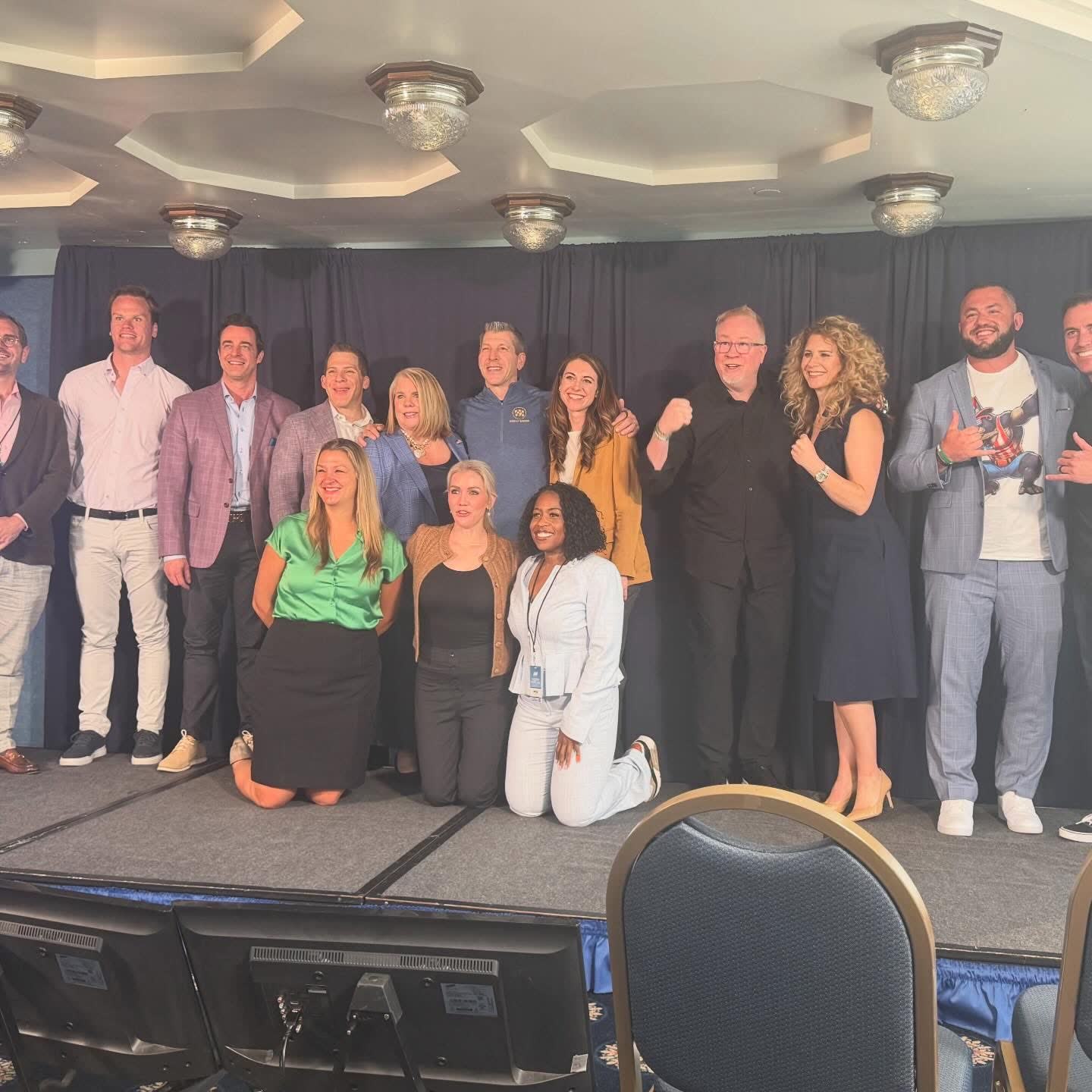 Team on stage at a leadership event
