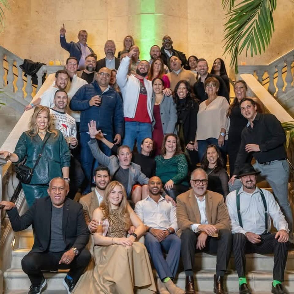 Group photo on a grand staircase at a holiday gathering